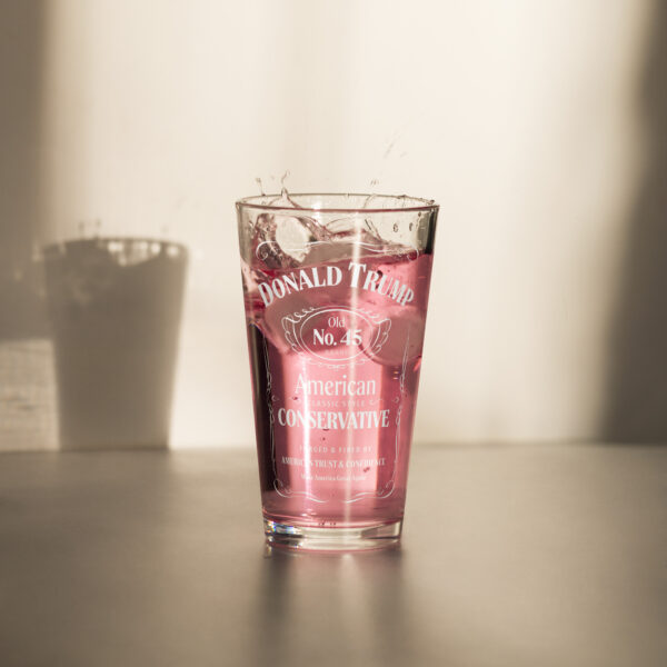 Our classic "American Conservative" Donald Trump pint glass filled with raspberry lemonade.